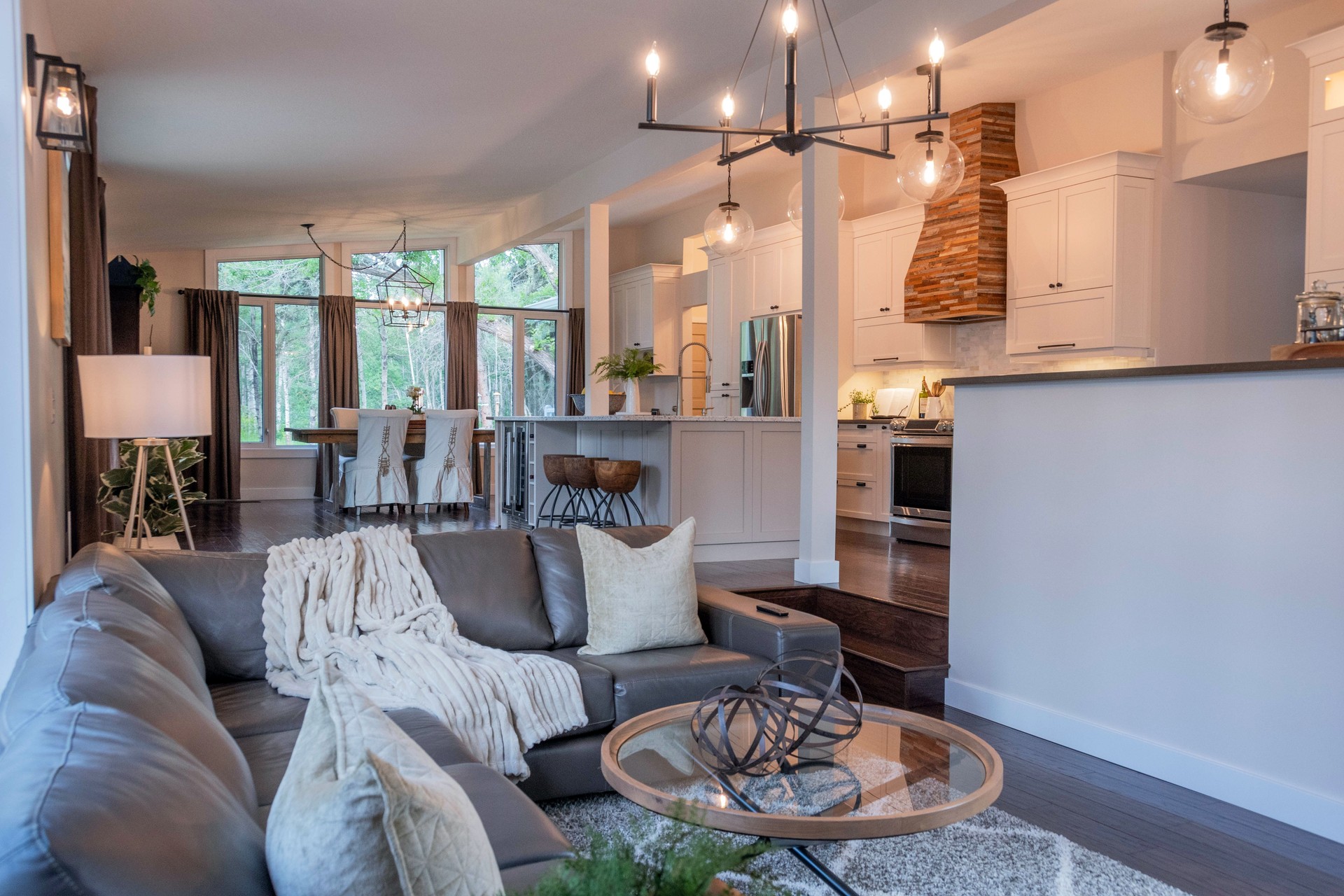 Sunken living room in renovated bungalow looking into modern country kitchen