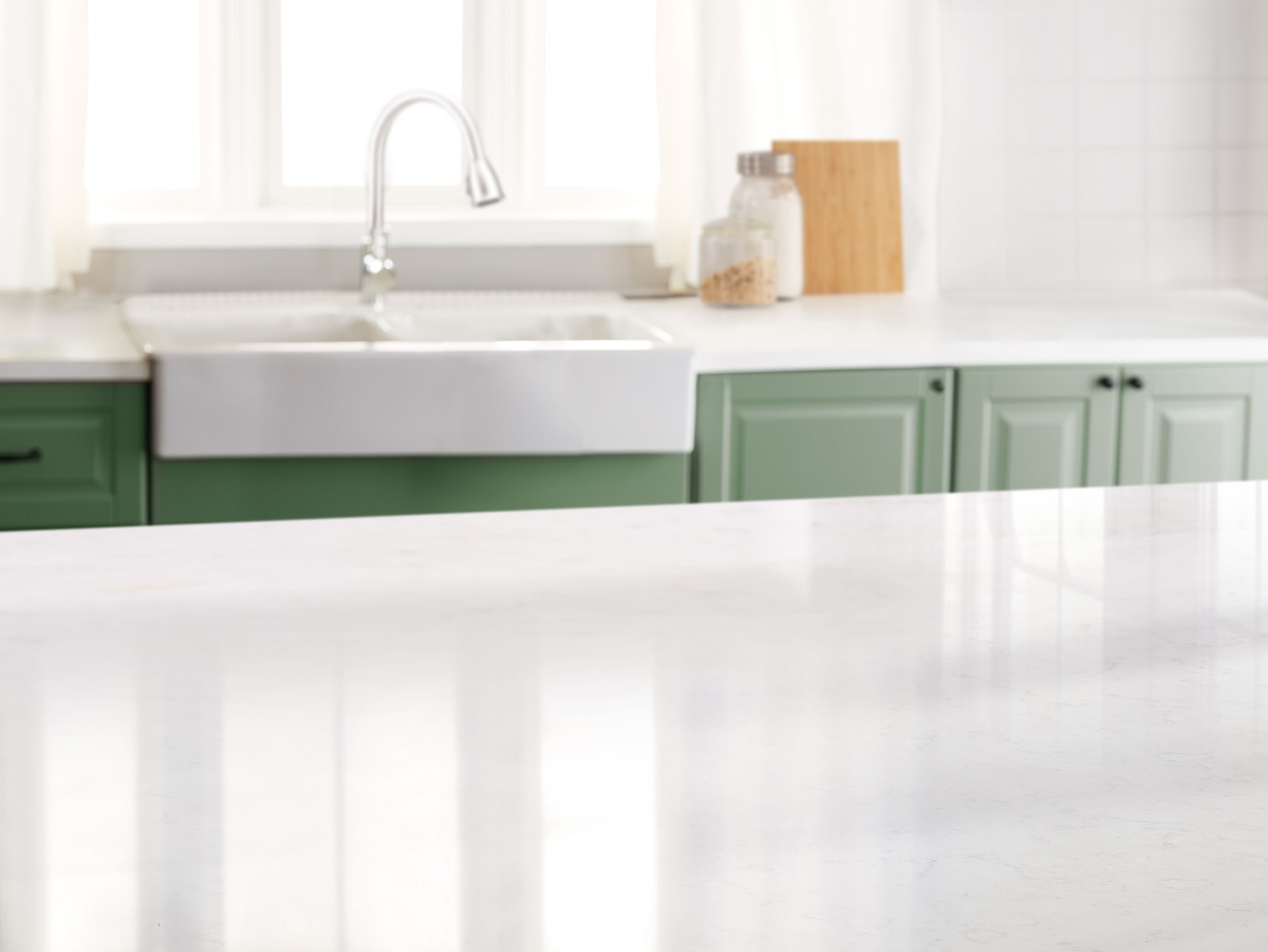 Kitchen with a marble counter top and sink in the background